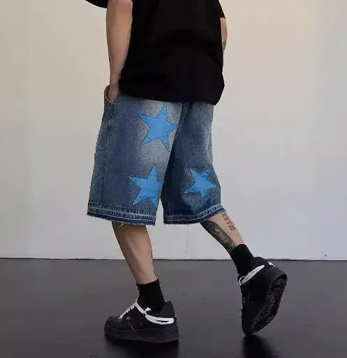 Man wearing Vintage Star Patch Jeans for Men with blue star patches, showcasing a trendy streetwear look.