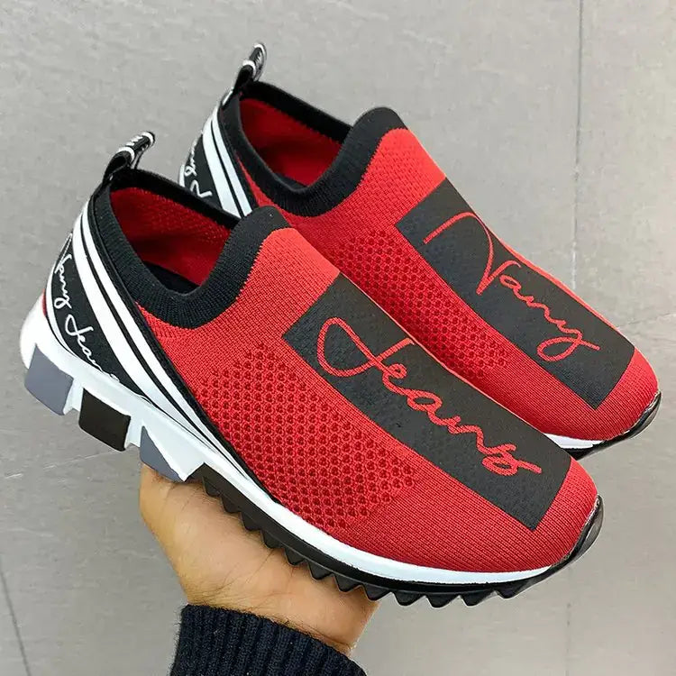 Red breathable sneakers with black mesh and stylish lettering, perfect for casual wear.