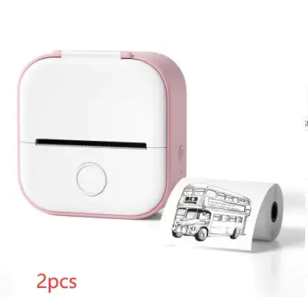Portable Mini Thermal Label Printer in pink with label roll and printed bus design.