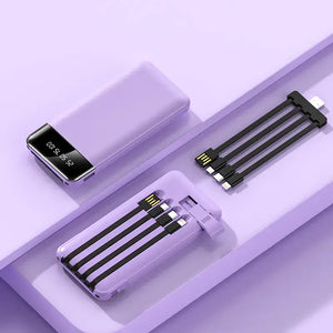High-capacity power bank with multiple charging cables on a purple surface, ideal for keeping devices powered.