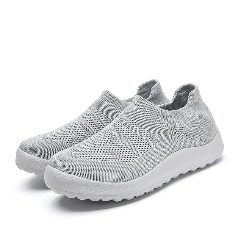 Casual Flyknit Slip-On Sneakers in light grey color, featuring a breathable flyknit upper for comfort and style.