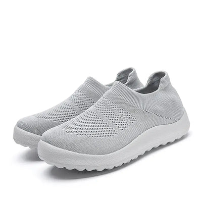 Casual Flyknit Slip-On Sneakers in light grey color, featuring a breathable flyknit upper for comfort and style.