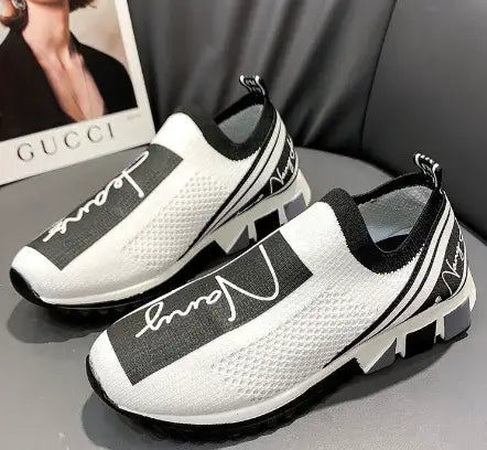 Breathable white and black woven sneakers with stylish design for casual wear and comfort.