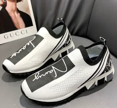 Breathable white and black woven sneakers with stylish design for casual wear and comfort.