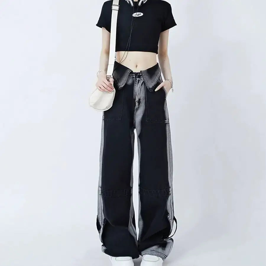 Woman wearing black cuffed jeans and a crop top, showcasing a stylish casual outfit.