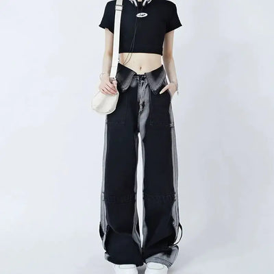 Woman wearing black cuffed jeans and a crop top, showcasing a stylish casual outfit.