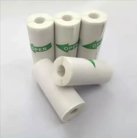 Portable Mini Bluetooth Printer paper rolls stacked, showcasing white design with green 'OPEN' label.