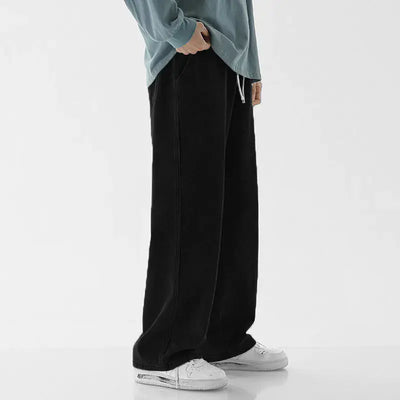 Casual Loose Straight Jeans for Men showcased in relaxed fit worn with a blue sweatshirt and white sneakers.
