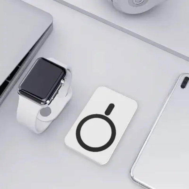 Wireless Power Bank 5000mAh placed next to a smartwatch and other devices on a desk.
