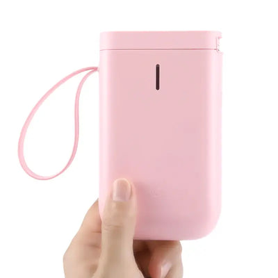 Bluetooth Label Printer in a pink compact design held in hand, showcasing its portability and style.