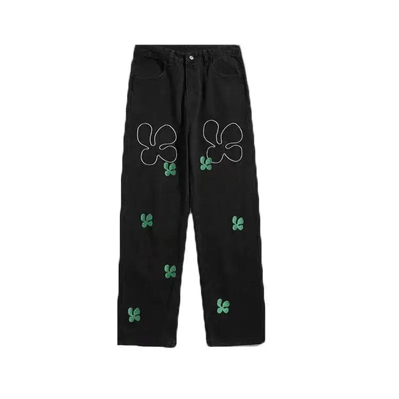 Embroidered High Street Jeans for Men with bold floral designs in green on black denim fabric.