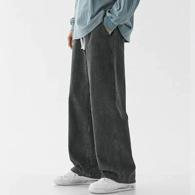 Casual Loose Straight Jeans for Men in dark grey, worn with a relaxed fit and paired with white sneakers.
