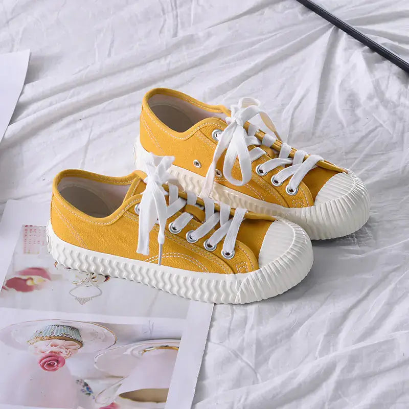 Yellow mens-and-womens-canvas-sneakers with white laces, perfect for casual outings and everyday wear.