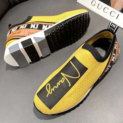 Stylish yellow breathable woven sneakers with black accents and logo, perfect for couples looking for comfort.