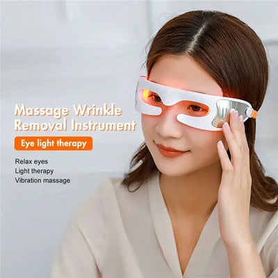 Eye Massager To Remove Dark Circles - woman using massage wrinkle removal instrument for light therapy and relaxation.