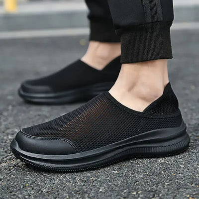 Slip-On Breathable Mesh Sneakers in black, showcasing a lightweight and breathable design for comfort and support.