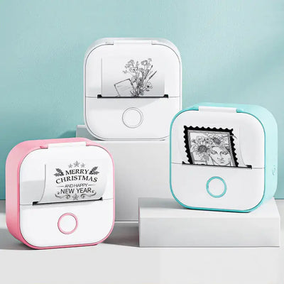 Portable Mini Thermal Label Printer in pink, white, and blue with printed labels on display.